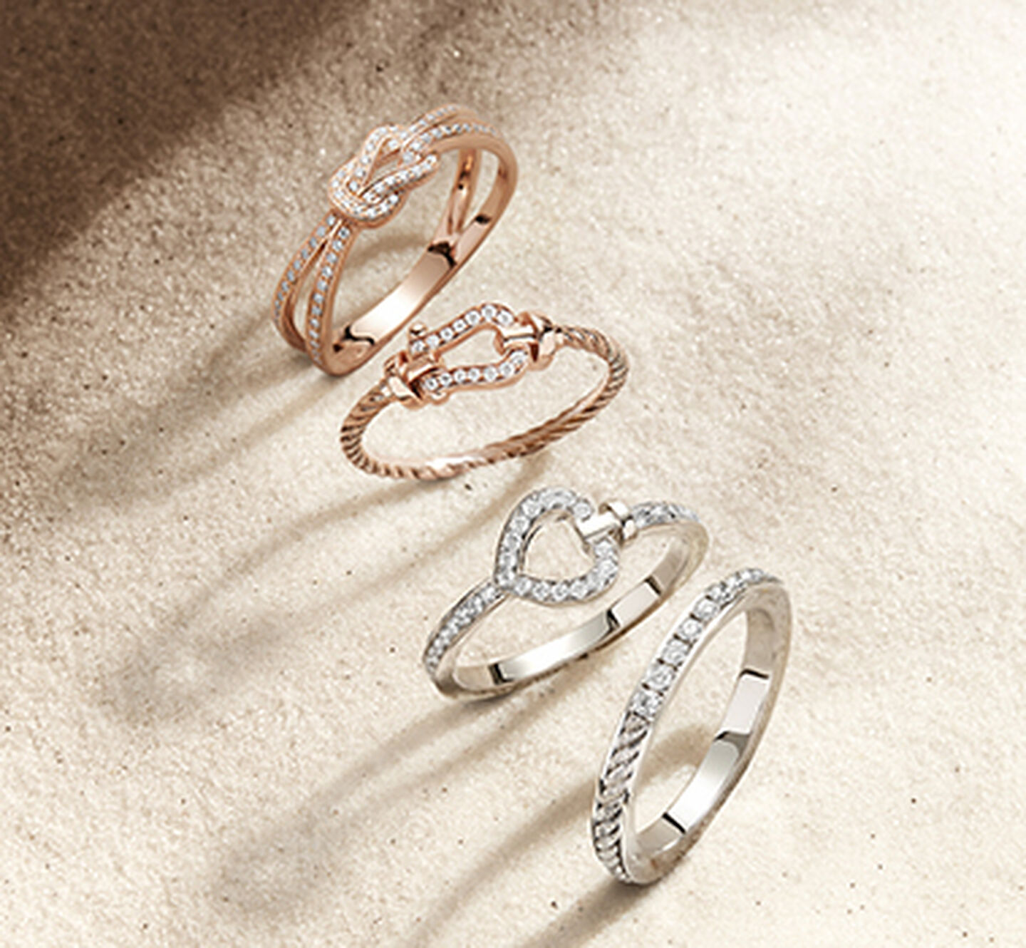 FRED force 10, pretty woman, and chance infinie rings on sand background.